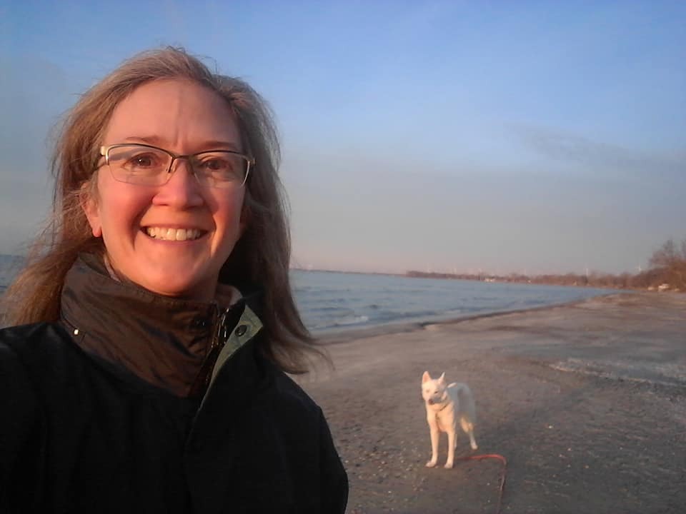 Beth on the beach with her dog